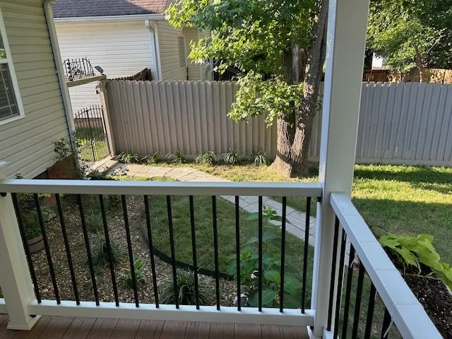 a view of a wooden chairs and table in the patio