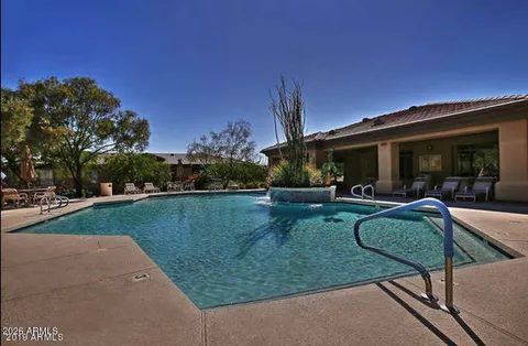 a view of a house with backyard patio and swimming pool
