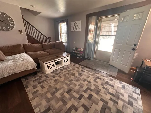 a living room with a couch and a rug