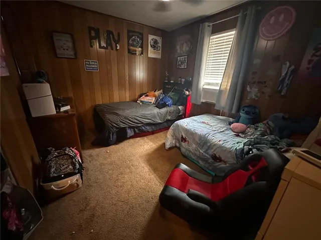 a bedroom with bed and a window