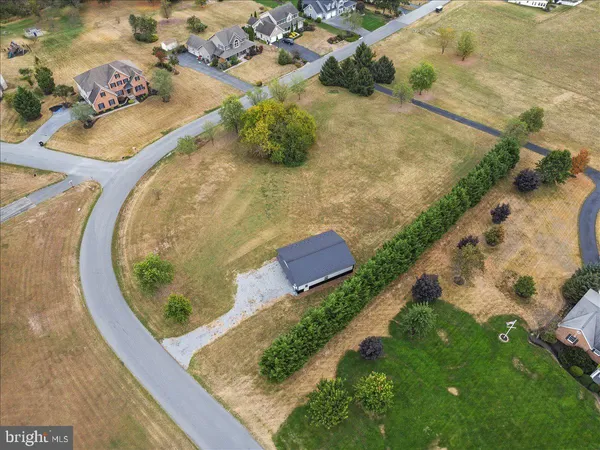 an aerial view of a house with a yard and lake view