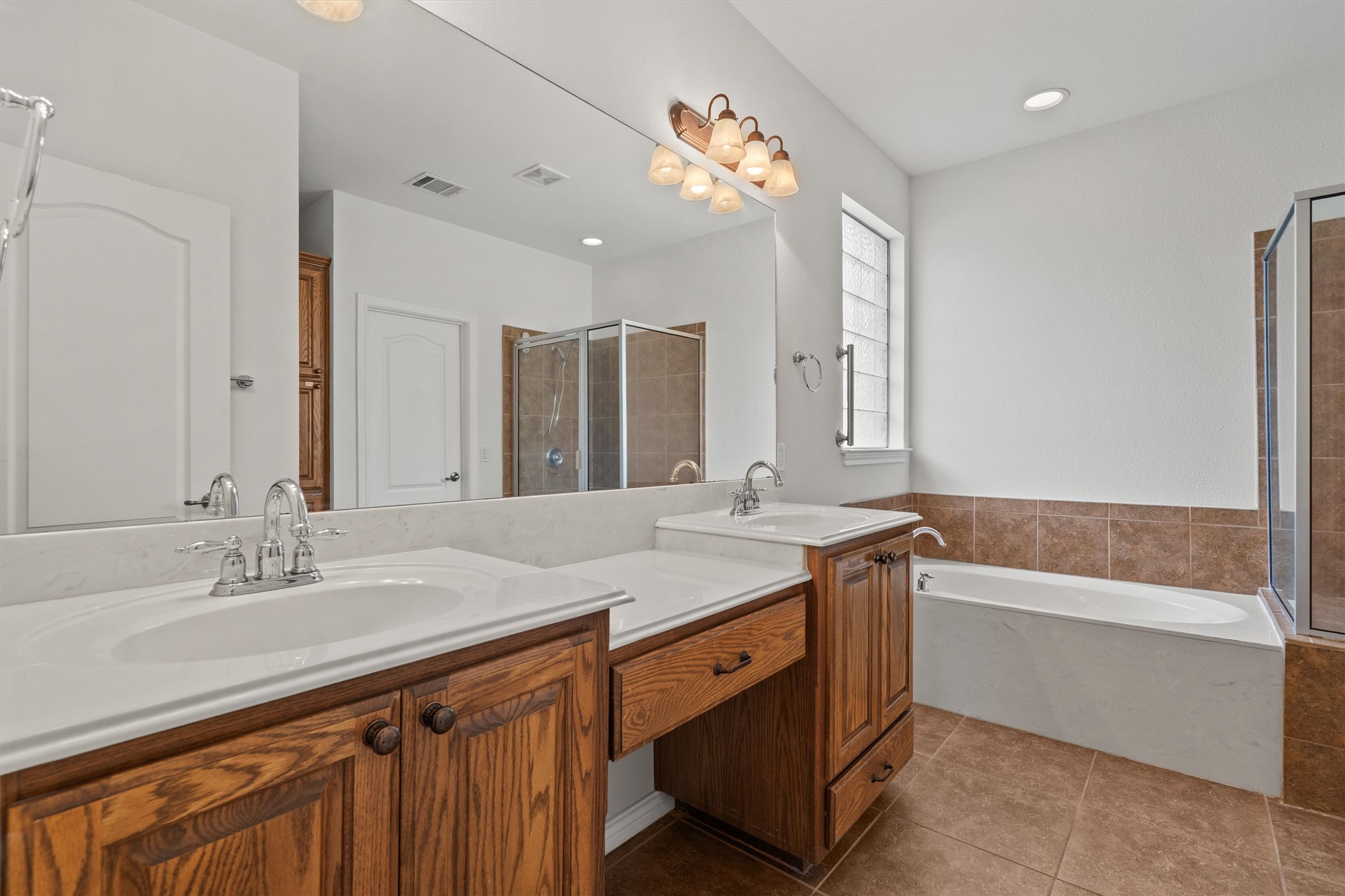 4612 Sonora Trace Georgetown, TX 78633 - Photo 26 of 36 a bathroom with a sink double vanity granite tub shower and a mirror