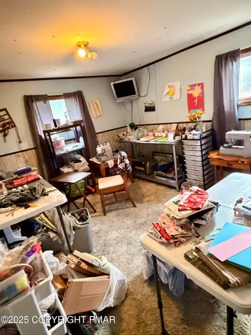 a living room with lots of furniture and clutter