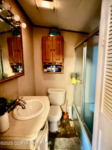 a bathroom with a toilet and a mirror