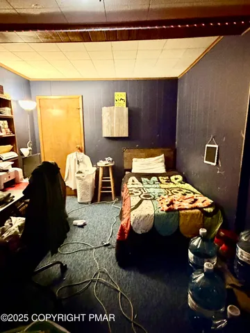 a bedroom with furniture and a mirror