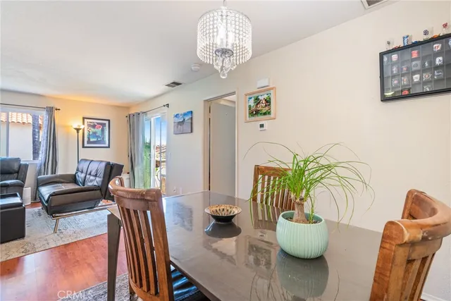 a view of a dining room with furniture and chandelier