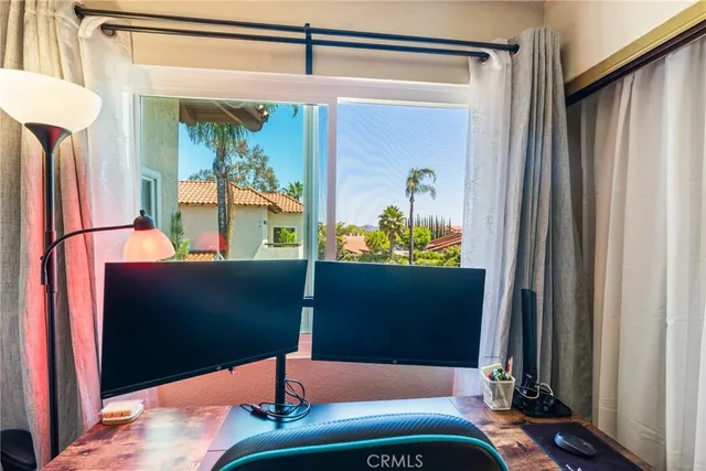 a bedroom with wooden floor and a potted plant