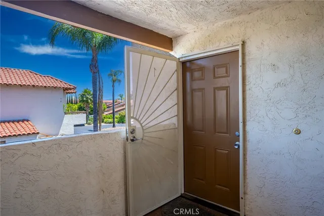 a view of a house with a potted plant from a hallway