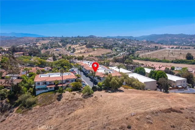 an aerial view of residential houses and outdoor space