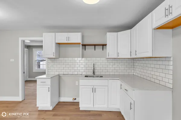 a kitchen with a sink cabinets and utility