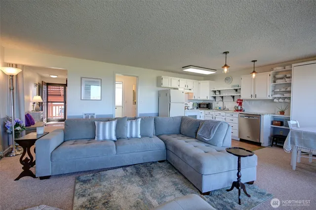 a living room with furniture and kitchen view
