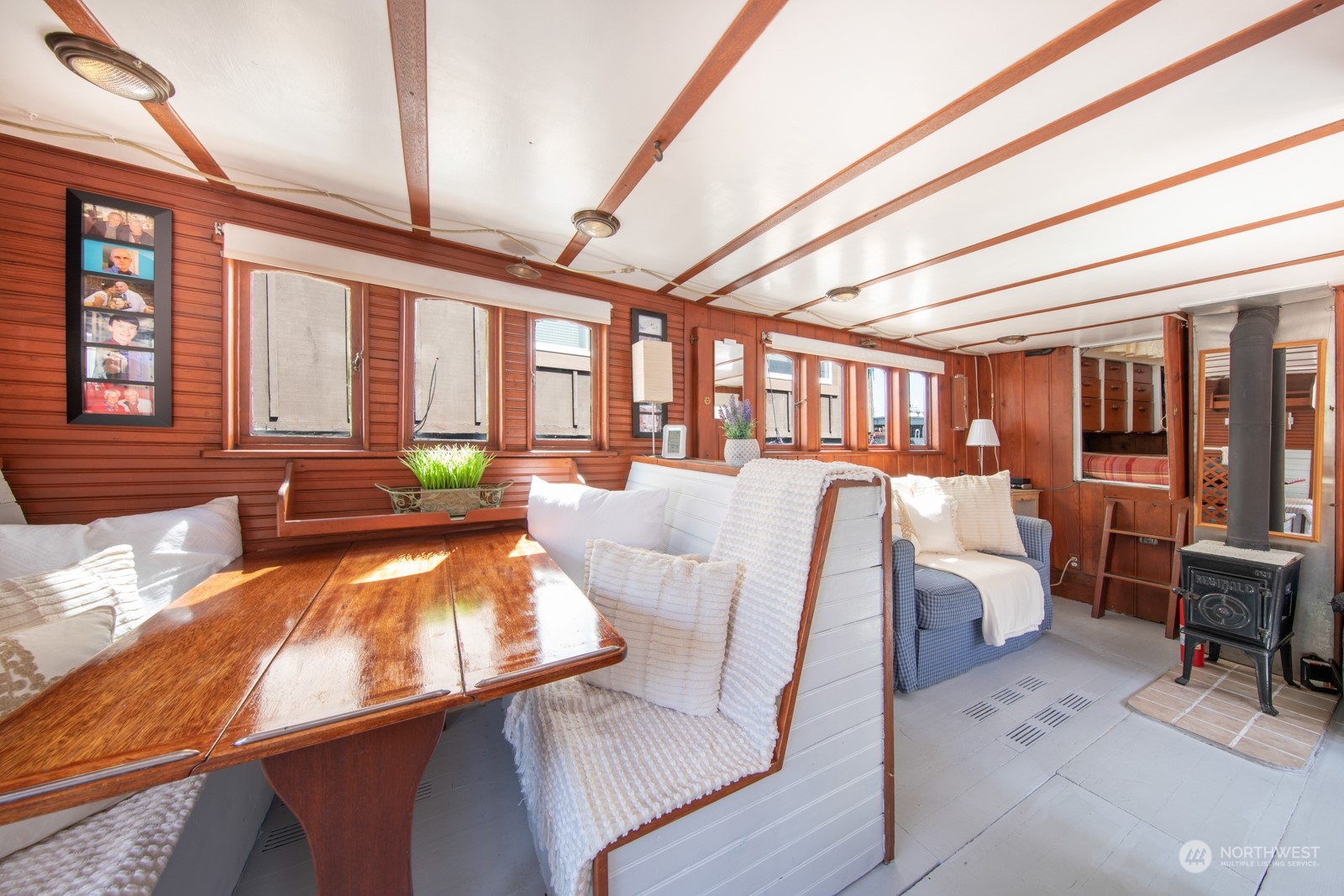 2143 North Northlake Way, Unit 34 Seattle, WA 98103 - Photo 2 of 26 a living room with furniture and floor to ceiling windows