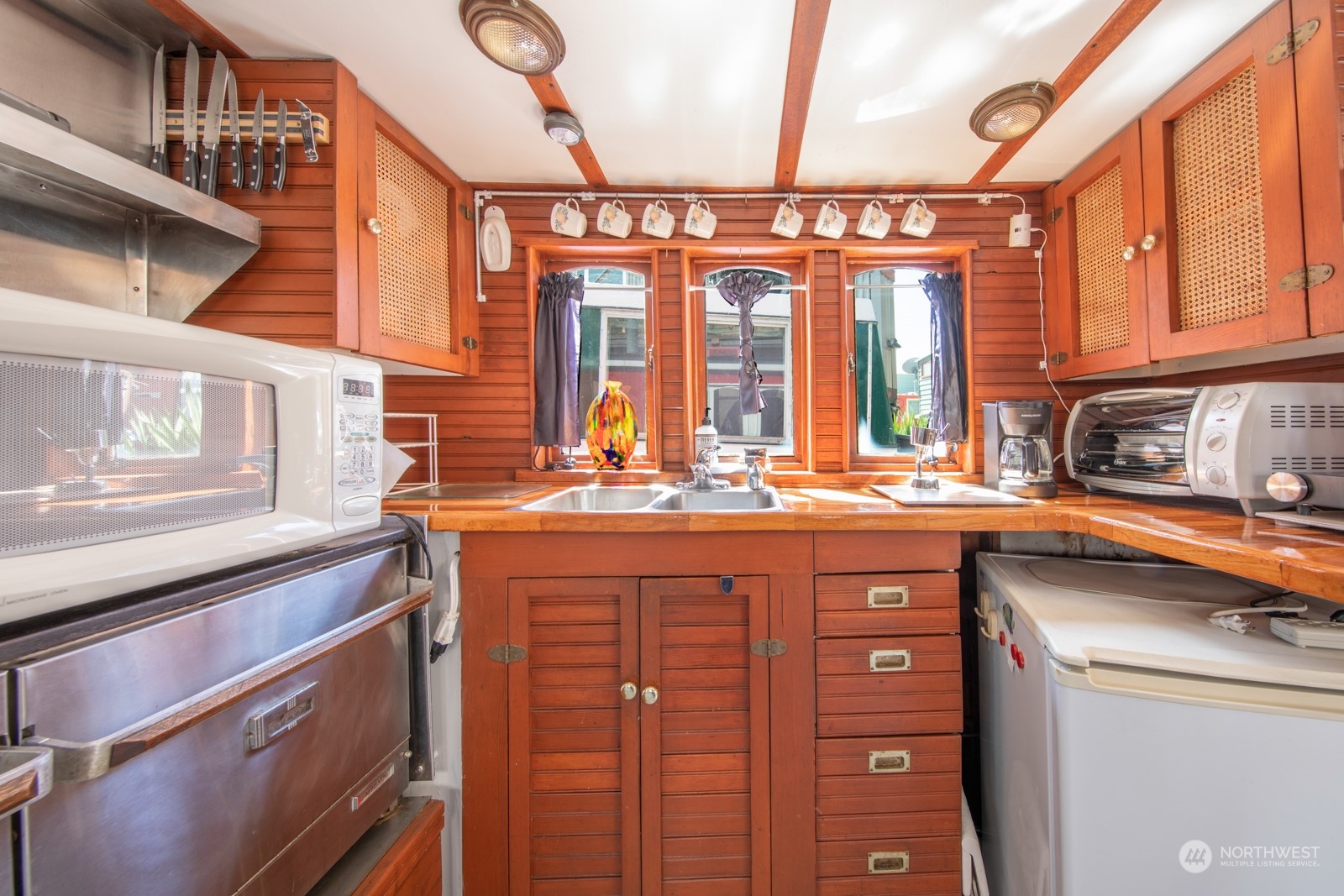 2143 North Northlake Way, Unit 34 Seattle, WA 98103 - Photo 9 of 26 a kitchen with stainless steel appliances granite countertop a sink and cabinets
