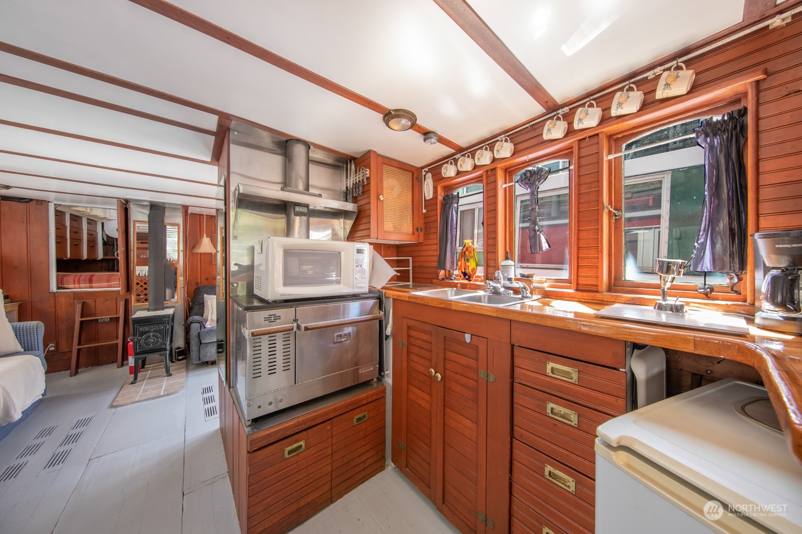 2143 North Northlake Way, Unit 34 Seattle, WA 98103 - Photo 10 of 26 a kitchen with stainless steel appliances granite countertop a sink and cabinets