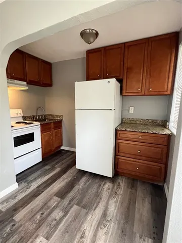 a kitchen with a refrigerator and a stove