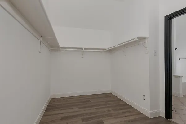 a view of a room with wooden floor