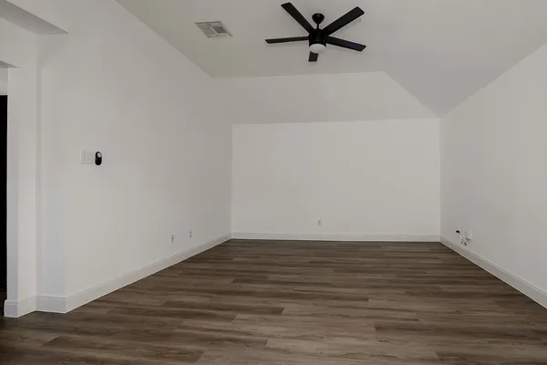 a view of a room with wooden floor