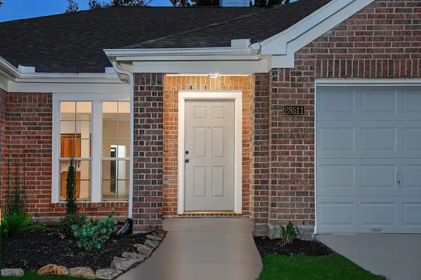 a front view of a house with a garden