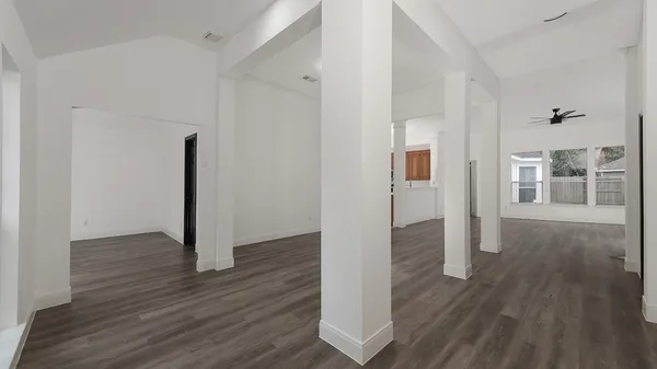 a view of a hallway with wooden floor