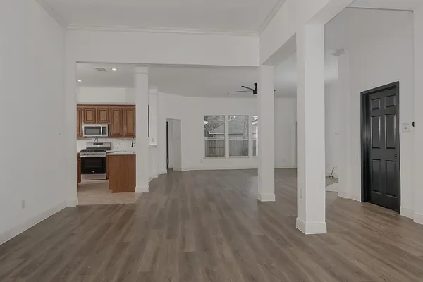 a view of a kitchen with wooden floor and a kitchen