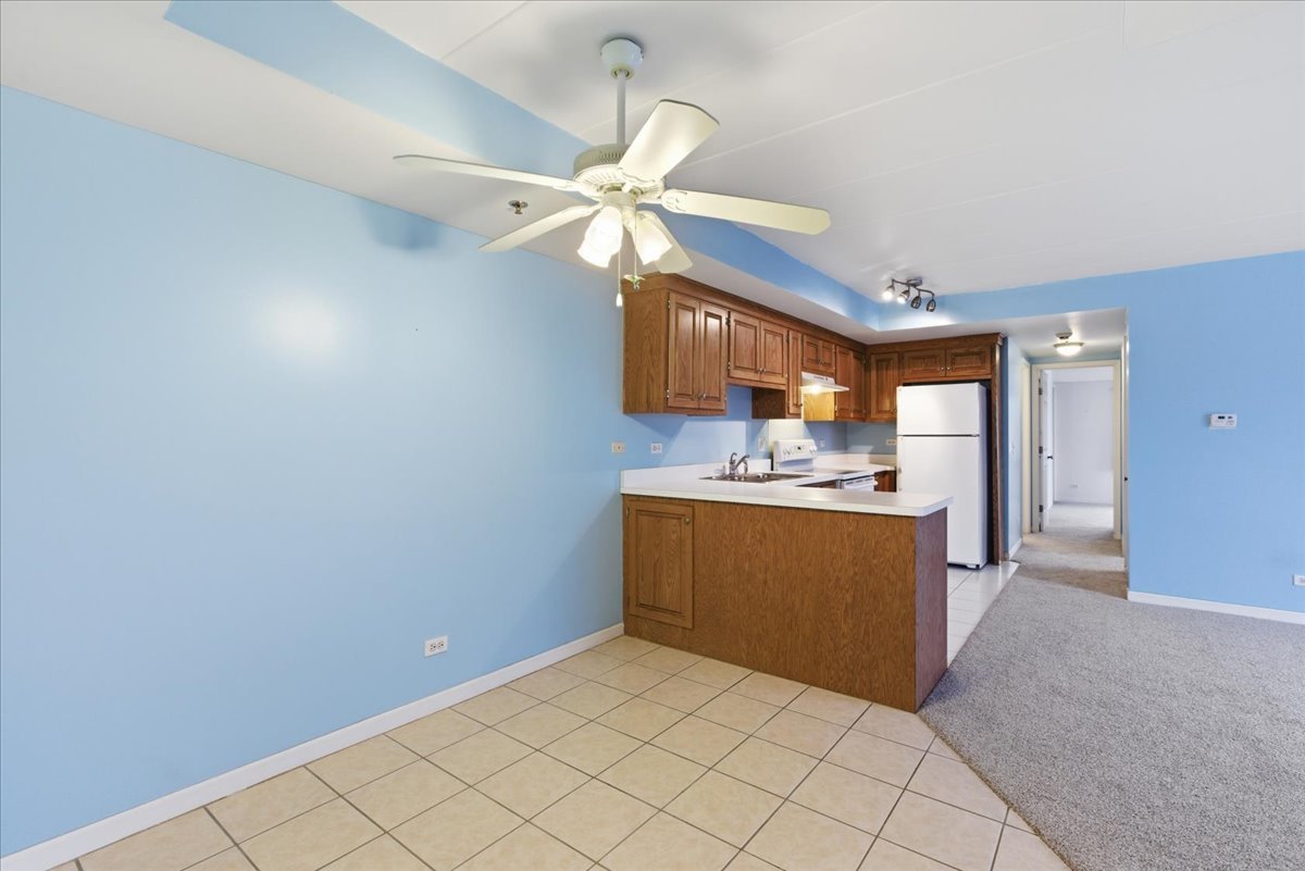 7316 40th Street, Unit 2E Lyons, IL 60534 - Photo 2 of 14 a view of a kitchen with a sink and dishwasher a refrigerator freezer