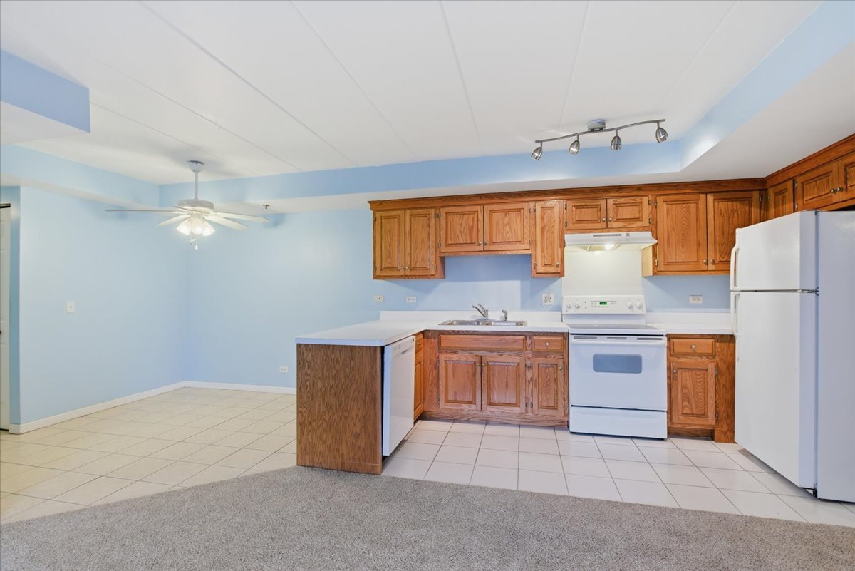 7316 40th Street, Unit 2E Lyons, IL 60534 - Photo 4 of 14 a kitchen with refrigerator cabinets and stove
