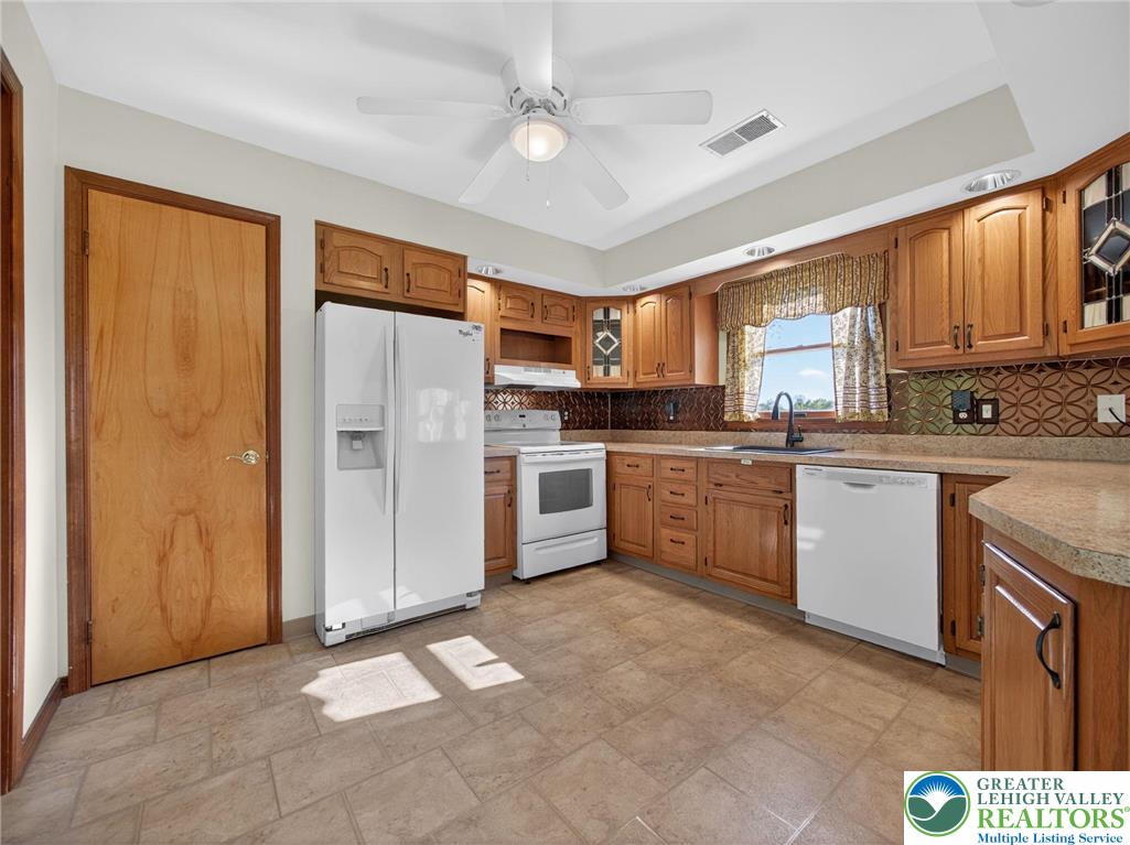 7098 Limerick Square Bath, PA 18014 - Photo 7 of 31 a kitchen with stainless steel appliances granite countertop a stove a sink dishwasher a refrigerator and a oven with wooden floor