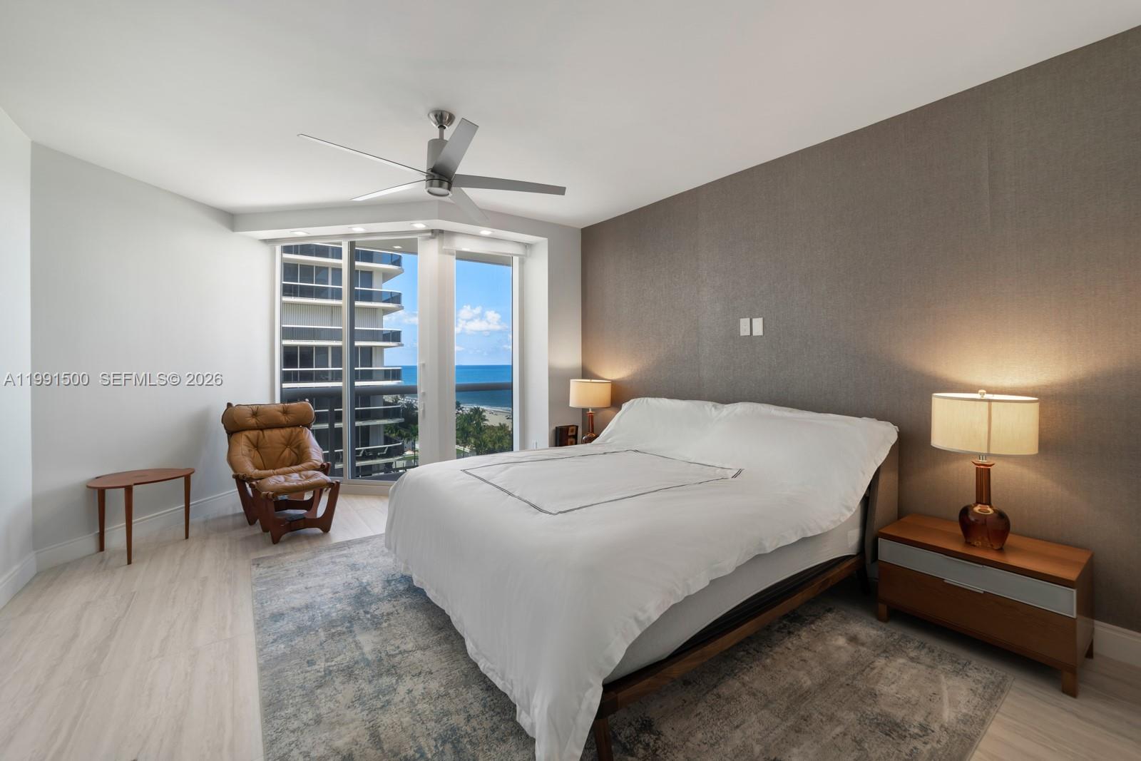 9559 Collins Avenue, Unit S8B Surfside, FL 33154 - Photo 16 of 42 a bedroom with a bed and a chandelier