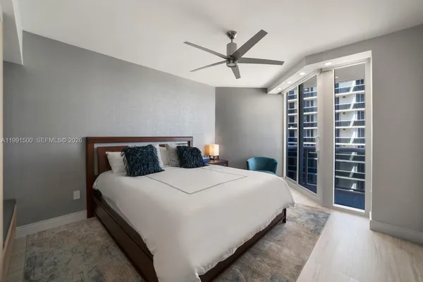 a large bed sitting in a bedroom and table