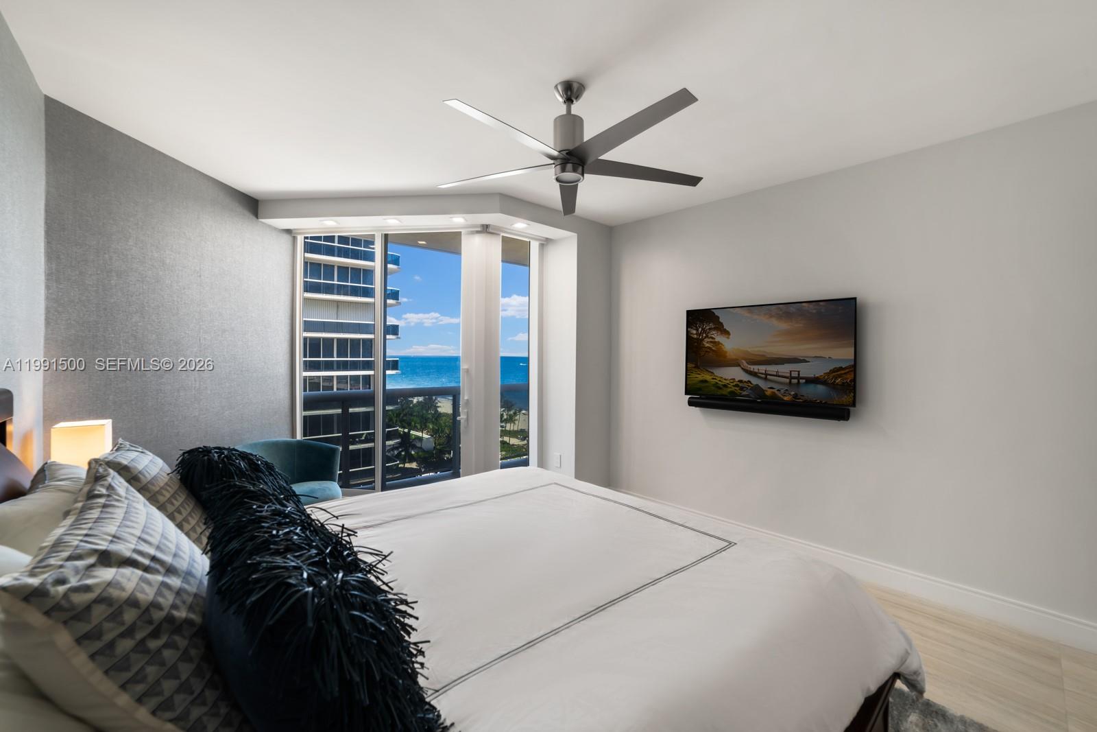 9559 Collins Avenue, Unit S8B Surfside, FL 33154 - Photo 20 of 42 a bedroom with a bed and a flat screen tv