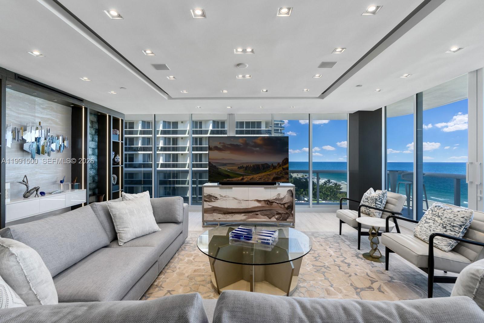 9559 Collins Avenue, Unit S8B Surfside, FL 33154 - Photo 2 of 42 a living room with furniture and a flat screen tv