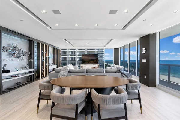 a dining room with furniture a rug and wooden floor