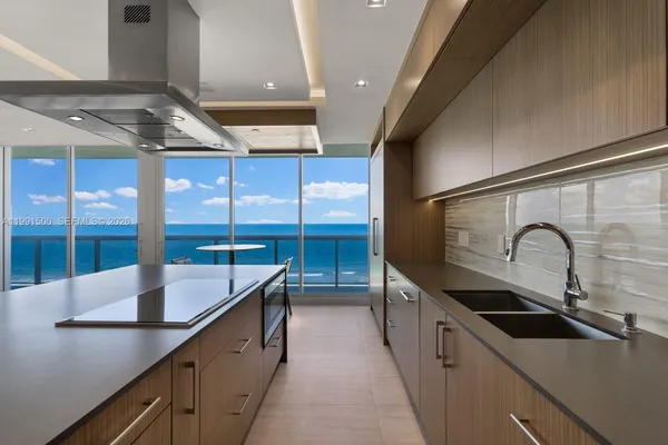 a kitchen with stainless steel appliances a sink and a stove