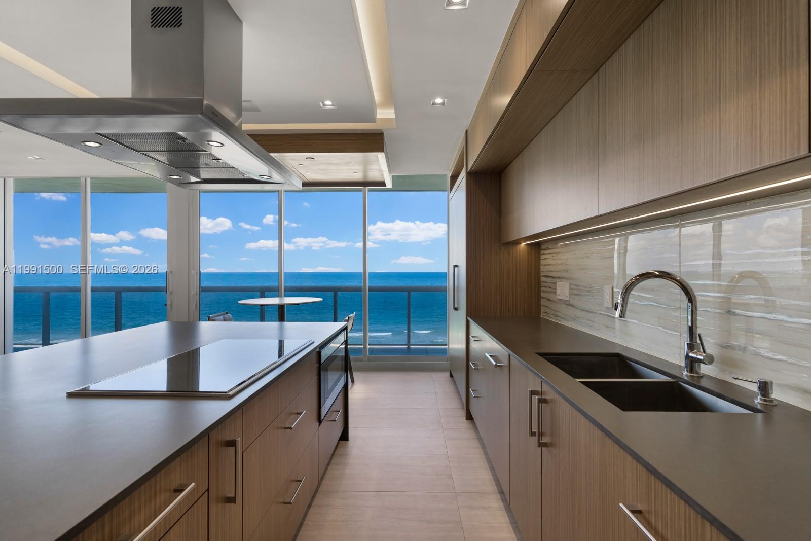 9559 Collins Avenue, Unit S8B Surfside, FL 33154 - Photo 29 of 42 a kitchen with stainless steel appliances a sink and a stove