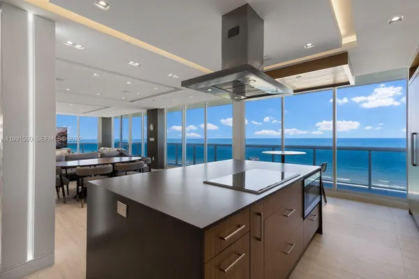 a kitchen with stainless steel appliances granite countertop a sink a stove and a refrigerator