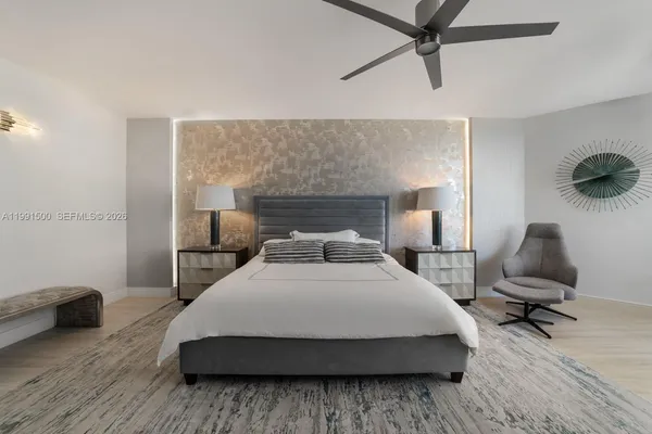 a bedroom with a bed and a chandelier