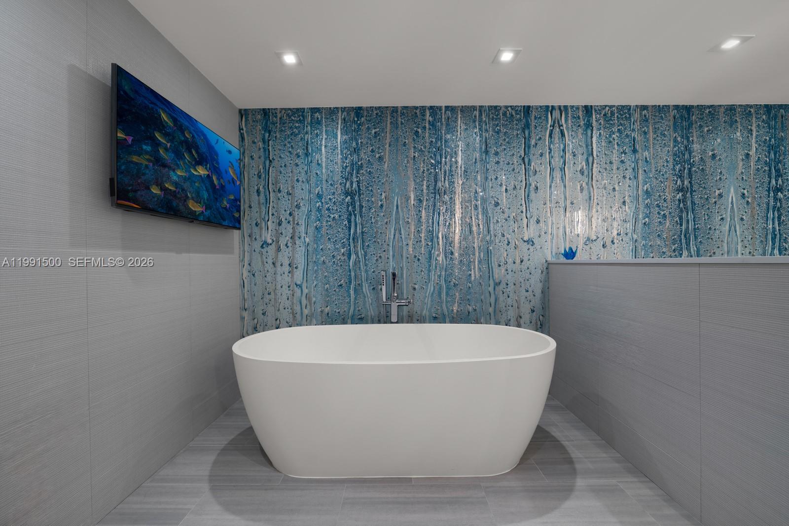 9559 Collins Avenue, Unit S8B Surfside, FL 33154 - Photo 10 of 42 a white bath tub sitting in a bathroom