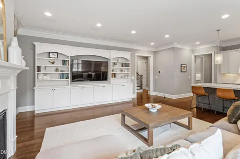 a living room with stainless steel appliances kitchen island granite countertop a couch and a view of living room