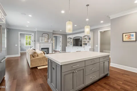 a view of living room kitchen with furniture and fireplace