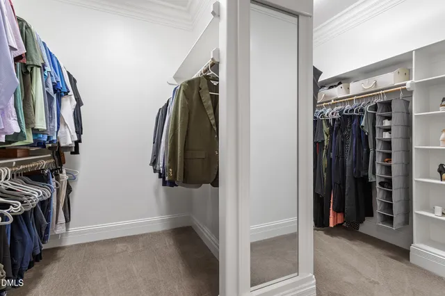 a view of walk in closet with clothes and shoes