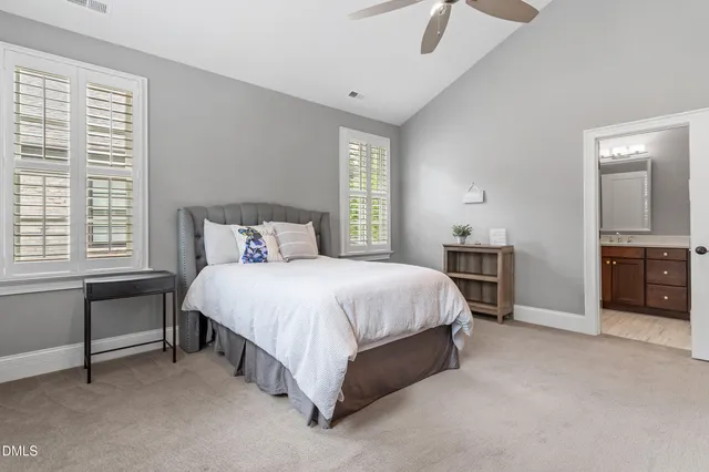 a spacious bedroom with a bed and a cabinets