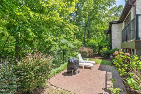 a view of a chair and tables in the backyard