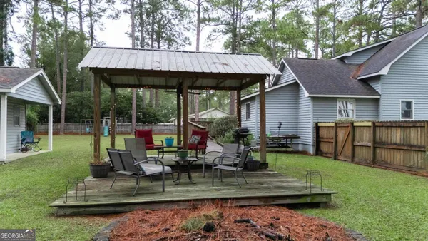 a view of a house with backyard porch and sitting area