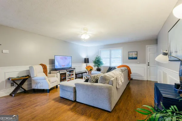 a living room with furniture and a flat screen tv