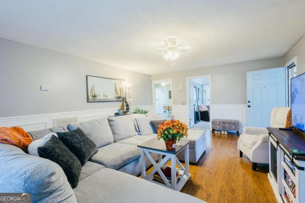 a living room with furniture and wooden floor