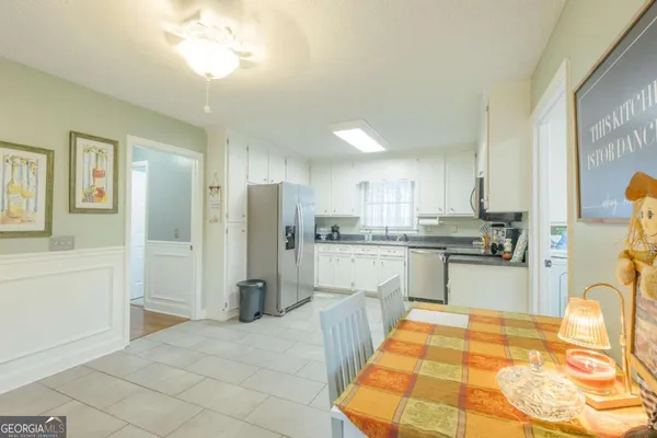 a kitchen with stainless steel appliances kitchen island granite countertop a refrigerator and a stove top oven