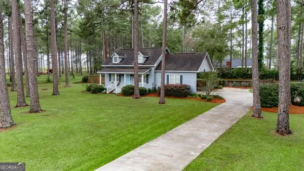 a front view of a house with a yard table and chairs