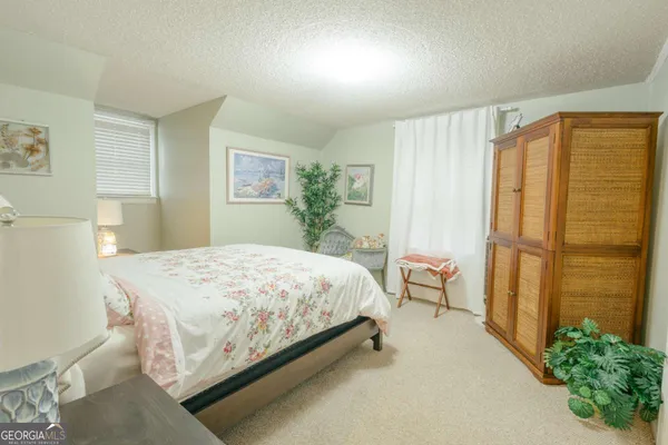 a large white bed in a white room