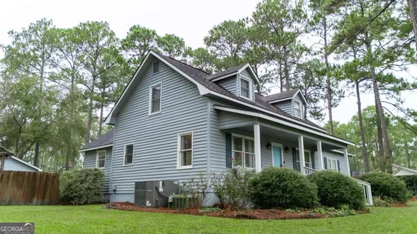 a front view of house with yard and green space