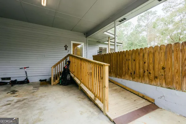 a view of a house with wooden fence